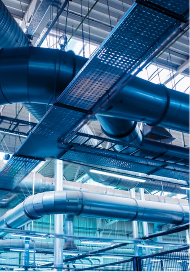 Ductwork and cable trays across an industrial ceiling