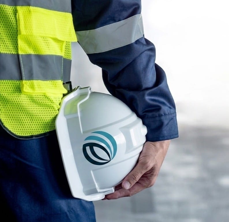 Thermal branded safety helmet held by a technician on site